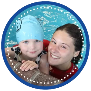 swimming lessons instructor and girl student at edge of pool