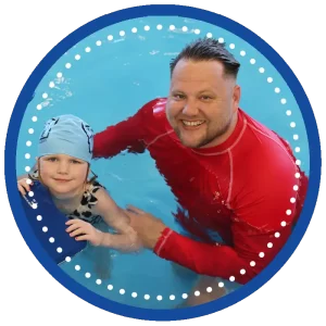 swim instructor and swim student in pool with swim board